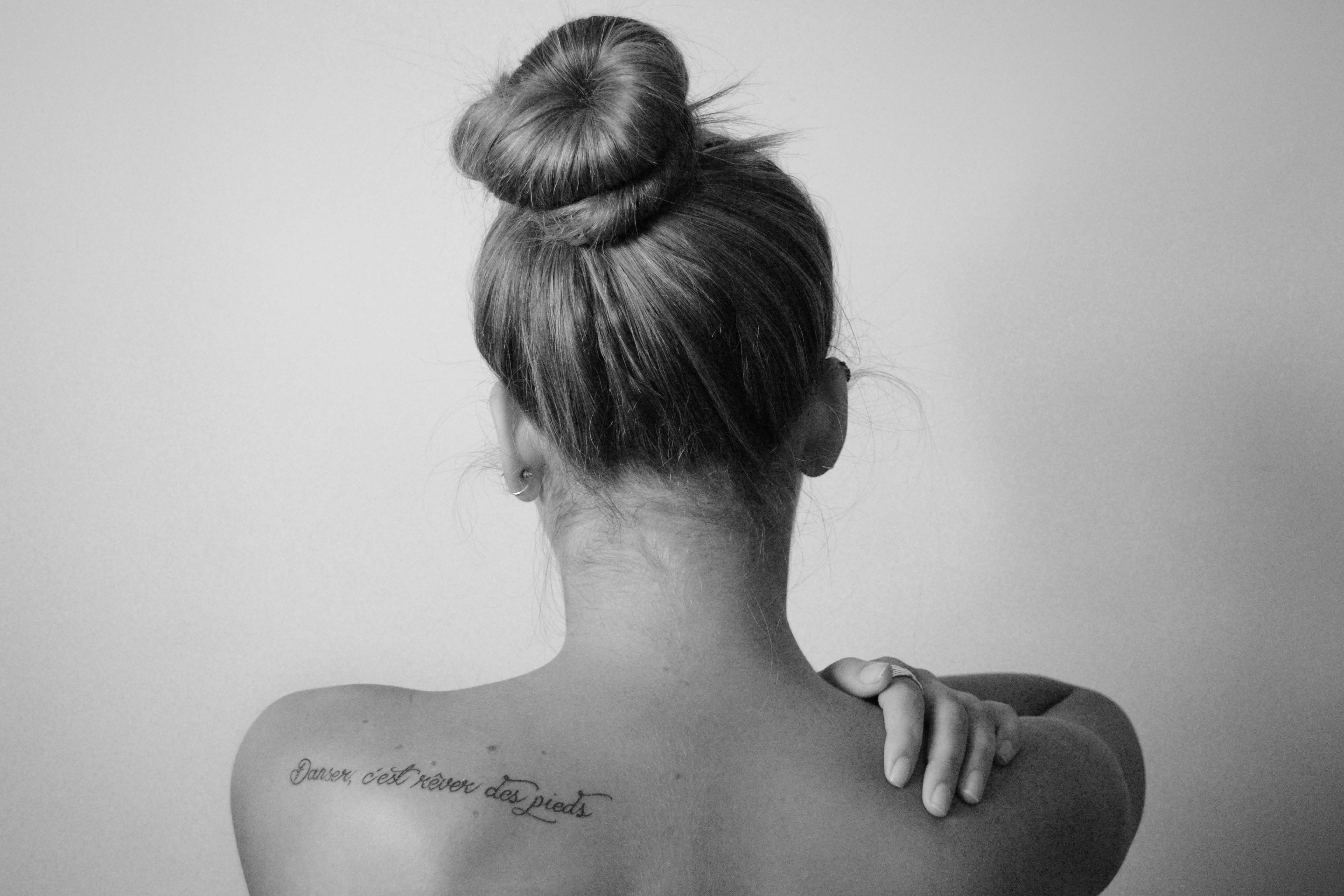 black and white image of a woman with her back to the camera