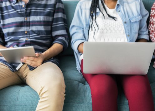 Cropped man and woman using electronic device