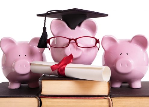 Piggy banks with a degree and graduation cap representing student finance