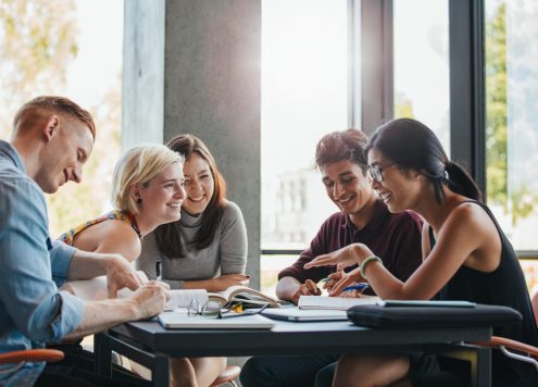 Group of university students studying and talking