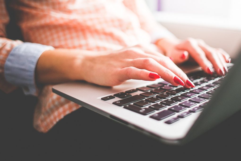 Person typing while sitting down