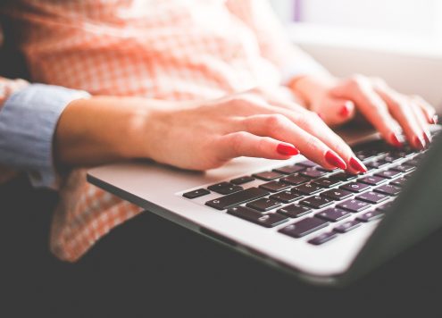 Person typing while sitting down