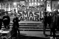 Protest banner reading 'Fight Racism. Fight Imperialism. Smash Capitalism'