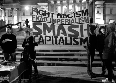 Protest banner reading 'Fight Racism. Fight Imperialism. Smash Capitalism'