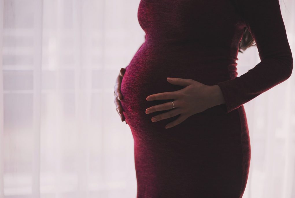 pregnant person in red dress