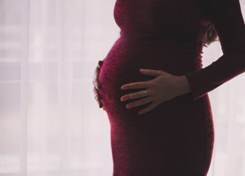 pregnant person in red dress
