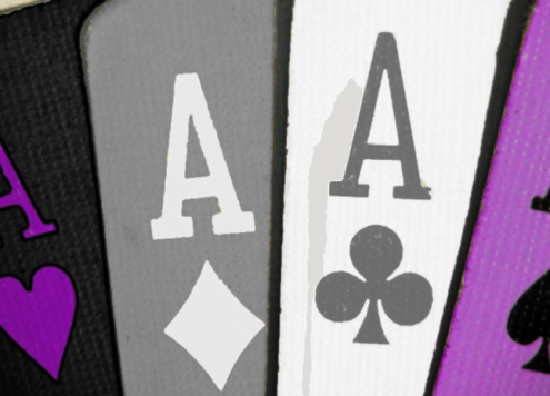 Four Ace playing cards in the colours of the asexual flag - purple, grey, black and white
